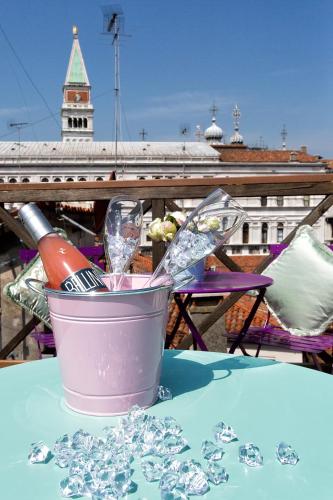 a table with a bucket of ice and a wine glass at Aquamare, boutique b&b in Venice