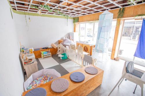 a childs room with a table and a crib at 一棟貸し切り宿 Hojo Machi Hostel in Kasai