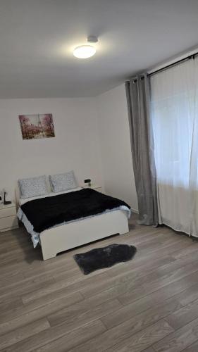 a bedroom with a bed and a large window at Casa 2 Magurele in Măgurele