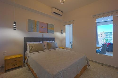 a bedroom with a large bed and a window at Piraeus Harbor Hideaway in Piraeus