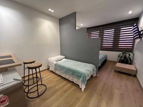 En eller flere senge i et værelse på Elegante lugar a pasos del metro