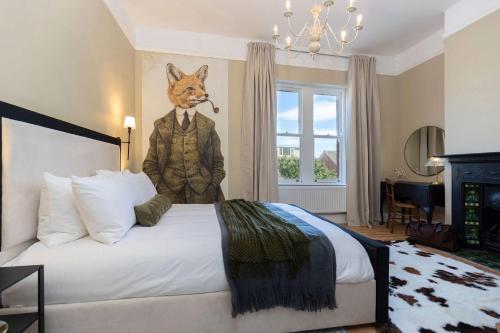 a bedroom with a bed with a statue of a fox at Nellie's Retreat - Luxury 3-Bed Pet Friendly Home in Guisborough in Guisborough