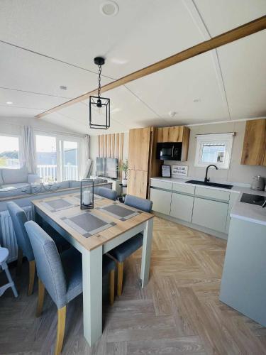 a kitchen and dining room with a table and chairs at Haven Berwick in Berwick-Upon-Tweed