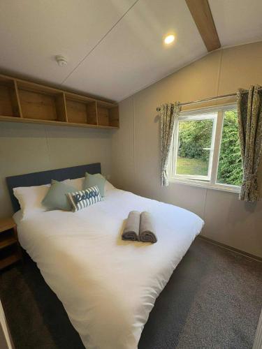 a large white bed in a bedroom with a window at Haven Berwick in Berwick-Upon-Tweed