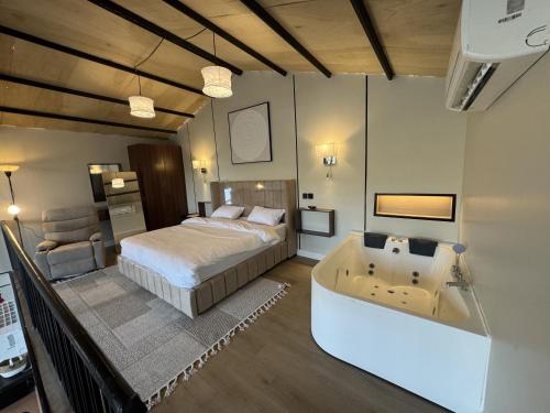 a bedroom with a bed and a bath tub in it at غصن الهدا in Al Hada
