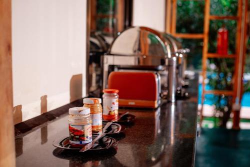 a kitchen counter with spices on a counter top at Nguchiro Palace Hotel in Moshi