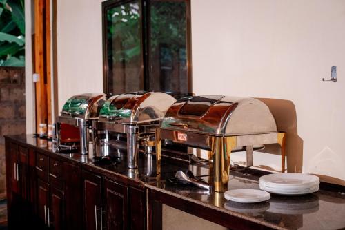 a group of four dishes sitting on top of a dresser at Nguchiro Palace Hotel in Moshi