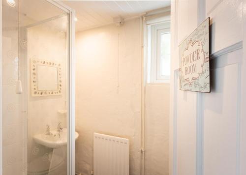a bathroom with a shower and a sink at Spacious 3 Bed Cottage Near Beaches in Georgeham