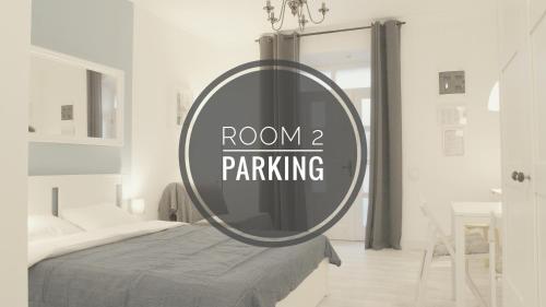 a round mirror in a bedroom with a bed at Apartmaji Diversorio in Izola
