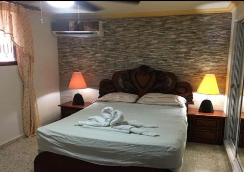 a bedroom with a bed with two towels on it at Apart-Hotel Costa Verde in Costa Verde