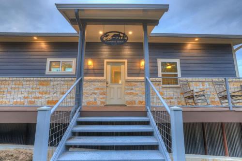 a front porch of a home with stairs at Esperanza Ranch w/Hot-tub, Fire pit, Gorgeous View in Stonewall