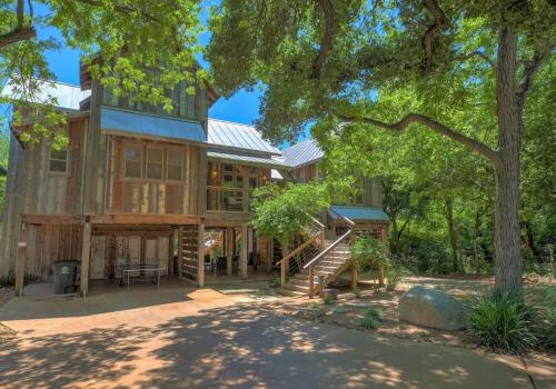 a large house with a tree at Life is Gruene-Riverfront Luxury-1Mi To GrueneHall in Gruene