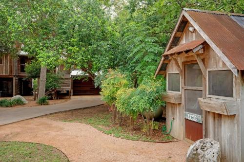 a small wooden building with plants in a yard at Life is Gruene-Riverfront Luxury-1Mi To GrueneHall in Gruene