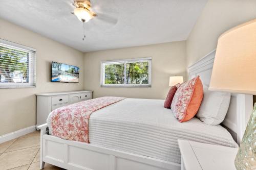 a bedroom with a bed and two windows at Sandy Cabana - 1104N in Siesta Key