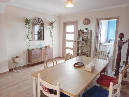 a dining room with a wooden table and chairs at Casa Centinela in Antequera