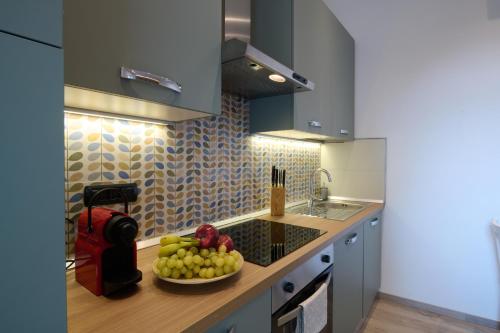 a kitchen with a bowl of fruit on a counter at La cà del Pin in Lierna