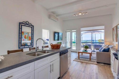 a kitchen with a sink and a living room at Jetty View 2 in San Diego