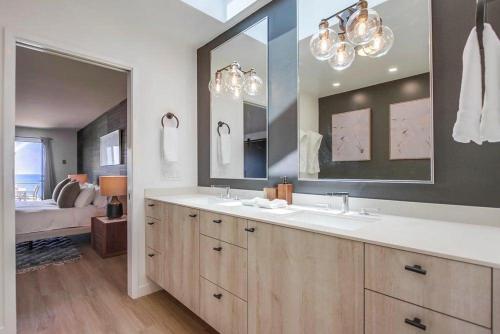 a bathroom with two sinks and a large mirror at Socal Style in Encinitas