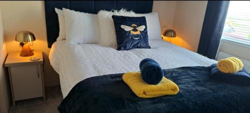 a bedroom with a bed with towels on it at Blue Lagoon Holiday ,Bude 79 in Cubert
