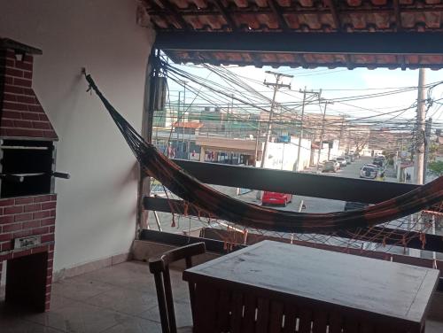 a hammock in a room with a view of a street at Varanda palmeiras in Cabo Frio