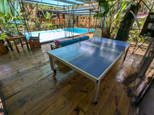 a ping pong table in front of a pool at Arboura Eco Cabinas in Uvita