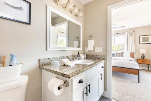 a bathroom with a sink and a mirror at Wine Country Private Backyard and Bocci Ball in Atascadero