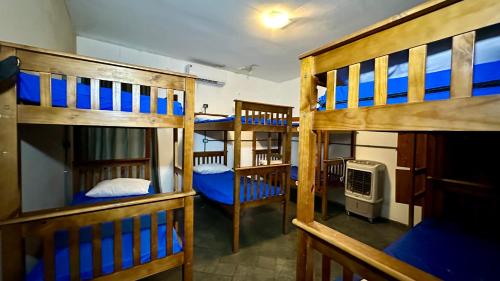 a group of bunk beds in a room at Curvão Surf House in Guarujá