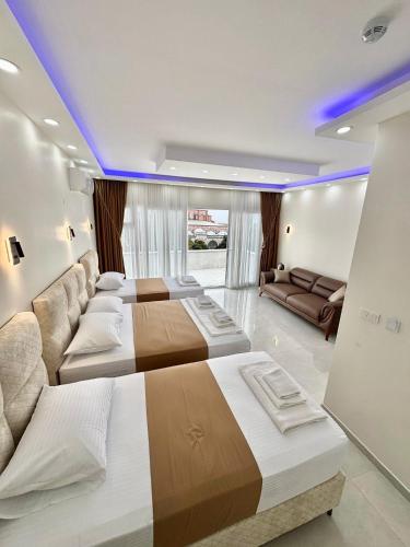 a bedroom with two beds and a couch at Hagia Sophia Place Hotel in Istanbul