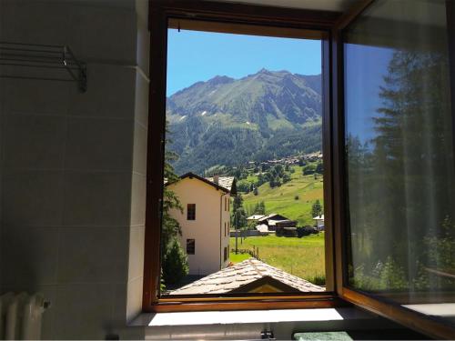 a window with a view of a mountain at R.T.A. Hotel Monte Rosa in Champoluc