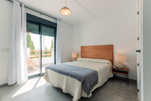 a bedroom with a bed and a large window at Villa sunset piscina privada in Luque