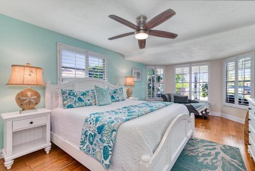 a bedroom with a bed and a ceiling fan at La Contento Casa - 5560 in Siesta Key
