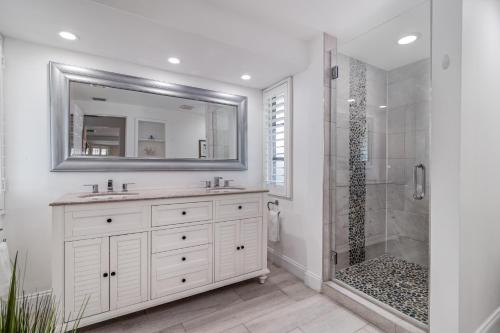 a white bathroom with a sink and a shower at La Contento Casa - 5560 in Siesta Key