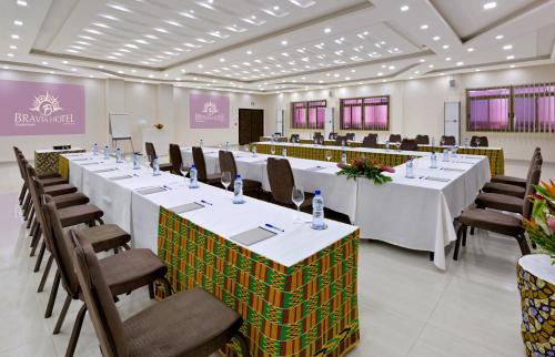 a large room with long tables and chairs at Bravia Hotel Ouagadougou in Ouagadougou