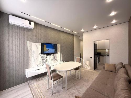 a living room with a table and a couch at Жилой комплекс Космос in Bishkek