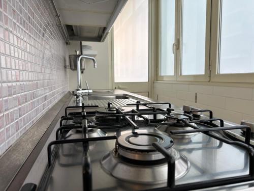 a stove top oven in a kitchen next to a window at Giaco Symphony Stay in Bari