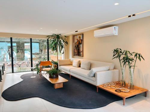 a living room with a couch and a rug at Studio Premium Batista Campos in Belém