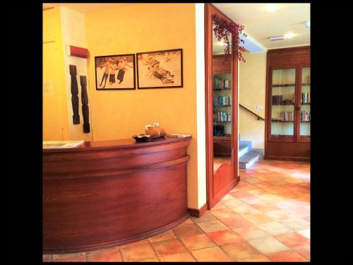 a lobby with a wooden counter in a room at R.T.A. Hotel Monte Rosa in Champoluc