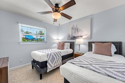 a bedroom with two beds and a ceiling fan at Siesta Dolce - 3750 in Siesta Key