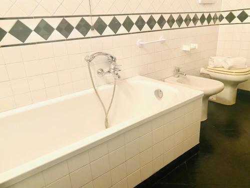 a bathroom with a bath tub and a toilet at Mediterranium in Loano