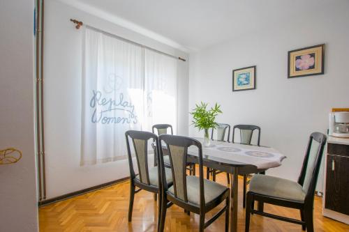 a dining room with a table and chairs at Apartments Rasic in Palit