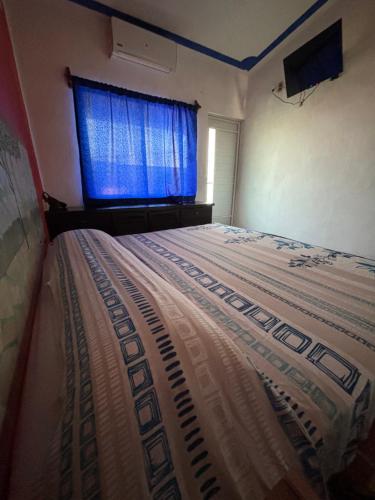 a bedroom with a large bed with a window at Costa Dorada in Barra de Navidad