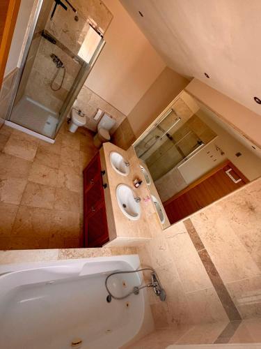 a large bathroom with a tub and a sink at Ático con vistas al mar y terraza in La Alcaidesa