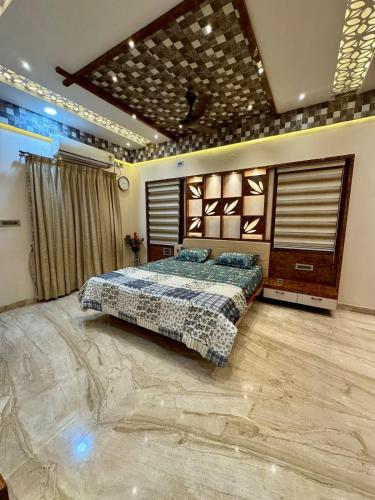 a bedroom with a large bed in a room at Ultra Luxurious 4 BHK VILLA in Bengaluru