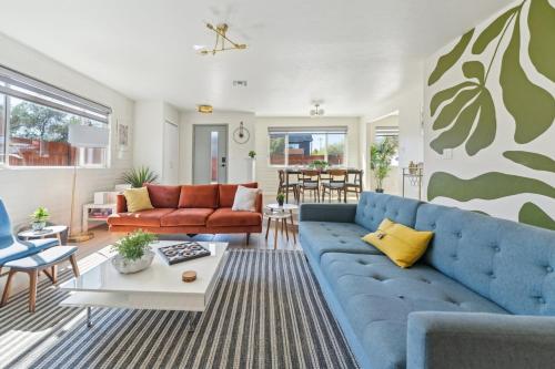 a living room with a blue couch and a table at Charming 3BR Midtown Home w Pool in Tucson