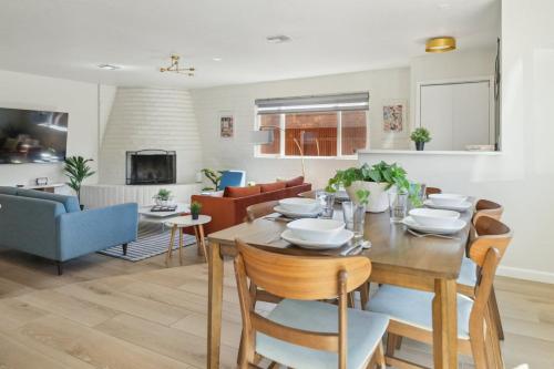a dining room and living room with a table and chairs at Charming 3BR Midtown Home w Pool in Tucson