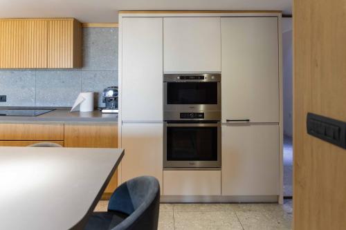 a kitchen with a refrigerator and a stove at Modern Duplex Loft in Skopje City Center with 3 Bedrooms in Skopje