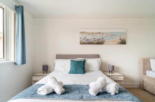 a bedroom with a bed with towels on it at 45 New Esplanade Court in Paignton