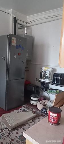 a kitchen with a stainless steel refrigerator in a kitchen at alojamiento a pasos del casino dreams y zona gourmet in Punta Arenas