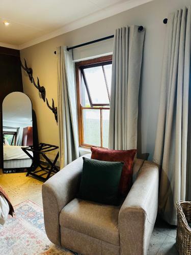 a living room with a chair and a window at Rest in the Village in Wilderness