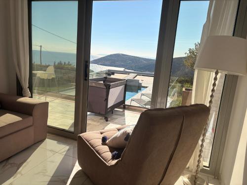 a living room with a chair with a teddy bear at Greece Sea Villas Kaki Thalassa 400m to the beach ,Heated pool ,Athens in Keratea